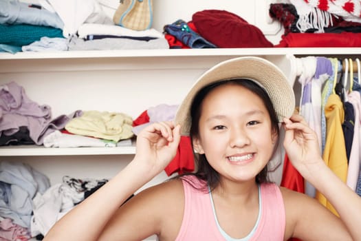 Portrait of a girl holding a hat on her head