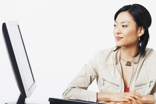 Close-up of a businesswoman smiling near a computer
