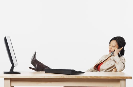 Side profile of a businesswoman talking on a cordless telephone