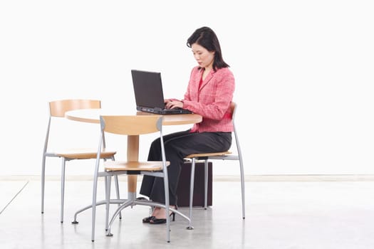 Side profile of a businesswoman using a laptop