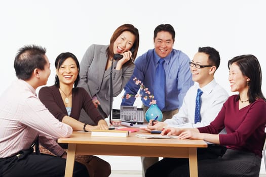 Three businessmen and three businesswomen in a meeting