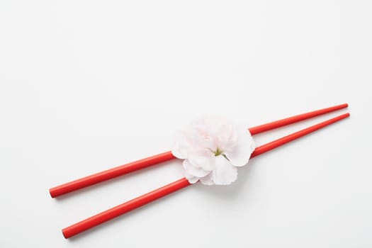 High angle view of a flower with a pair of chopsticks