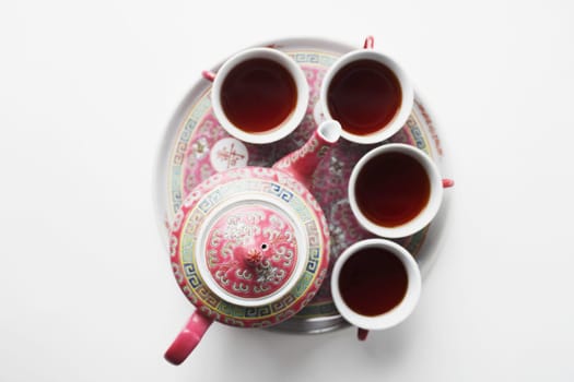 High angle view of tea cups with a teapot on a tray