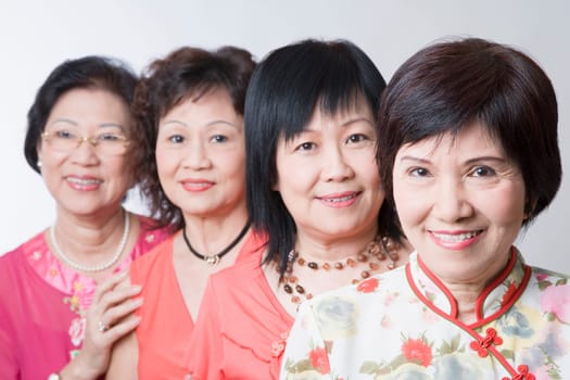 Portrait of three senior women and a mature woman smiling