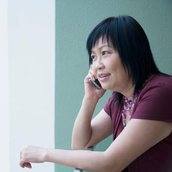Side profile of a mature woman talking on a mobile phone