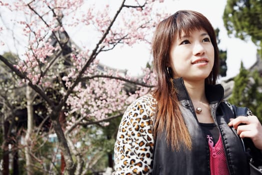 Low angle view of a young woman looking up thinking
