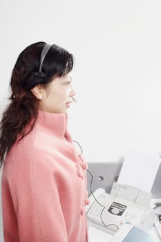 Side profile of a mature woman wearing a headset