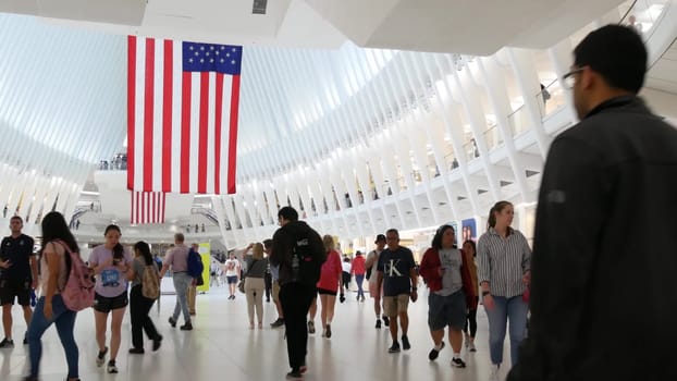 New York City, United States - 10 Sept 2023: World Trade Center Oculus transport hub architecture. Manhattan Downtown Financial District, USA urban life. People. September 11 remembrance american flag