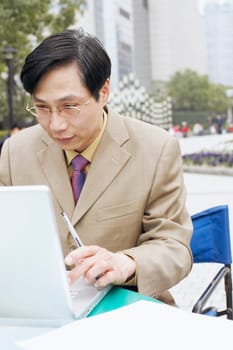 Close-up of a businessman using a laptop