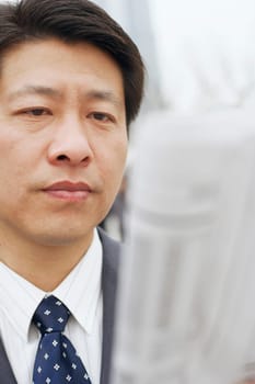 Close-up of a businessman reading a newspaper