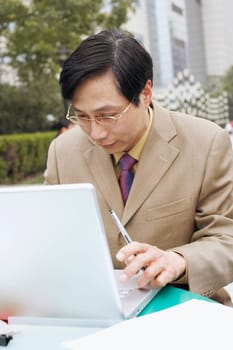 Close-up of a businessman using a laptop