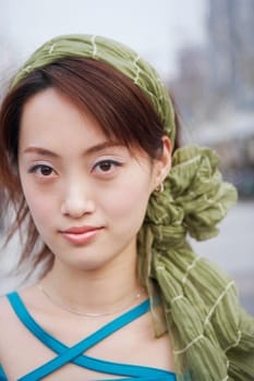 Portrait of a young woman wearing a scarf