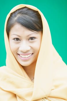 Portrait of a young woman wearing a scarf smiling