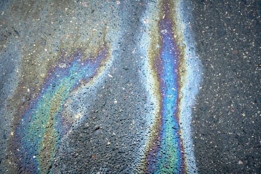 Abstract background featuring a colorful oil stain on asphalt