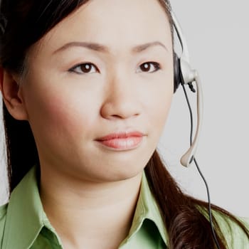 Close-up of a female customer service representative looking away and thinking