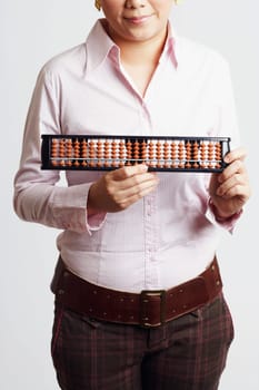 Mid section view of a businesswoman holding an abacus