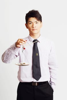 Portrait of a businessman weighing paper currency with coins on a weighing scale