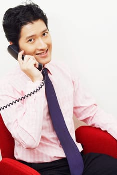 Portrait of a businessman talking on the telephone and smiling