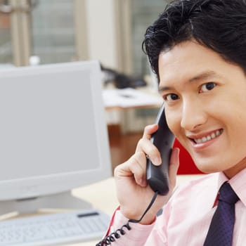 Portrait of a businessman talking on the telephone and smiling
