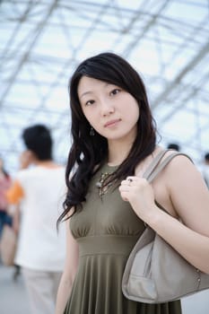 Portrait of a young woman standing in a corridor