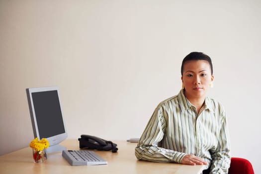 Portrait of a young woman sitting in an office