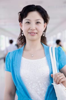 Portrait of a mid adult woman standing in a corridor and smiling