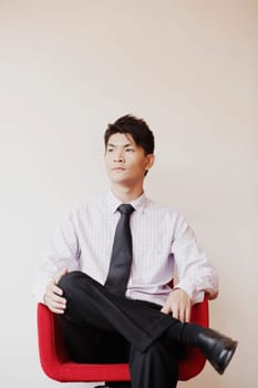 Businessman sitting in an armchair and thinking