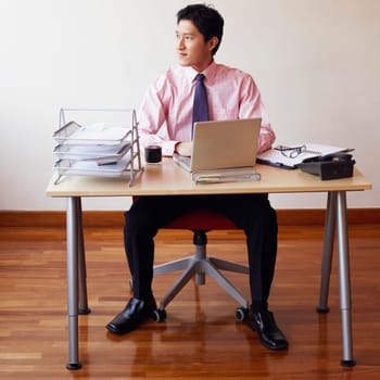 Businessman sitting in an office and thinking