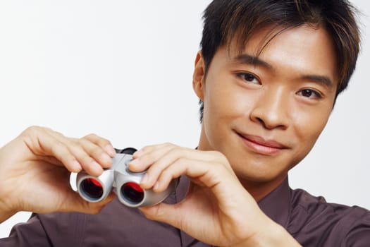Portrait of a businessman holding a pair of binoculars and smiling
