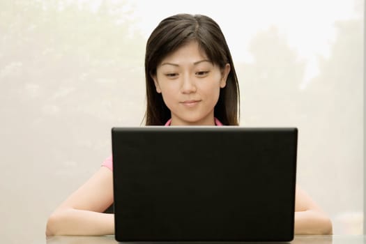 Close-up of a female office worker using a laptop