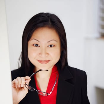 Portrait of a businesswoman holding a newspaper and smiling