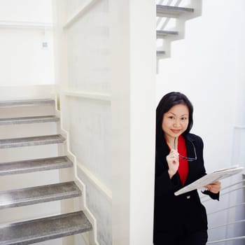 Portrait of a businesswoman holding a newspaper and smiling