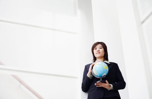 Portrait of a businesswoman holding a globe