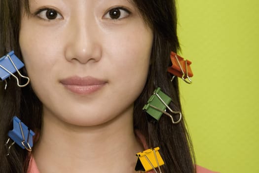 Portrait of a young woman with paper clips in her hair