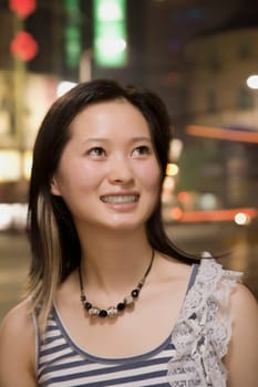 Close-up of a young woman looking up and smiling