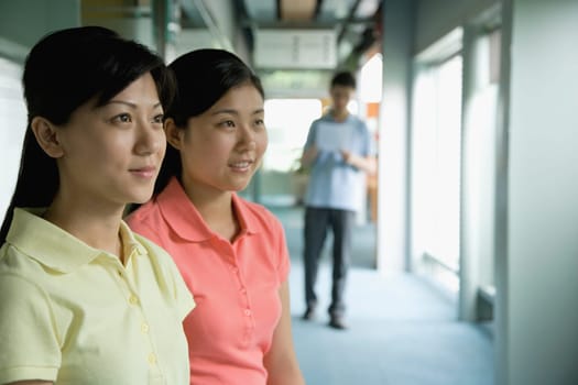 Close-up of two female office workers looking away
