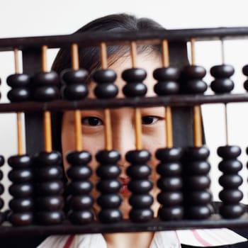 Portrait of a businesswoman holding an abacus and smiling