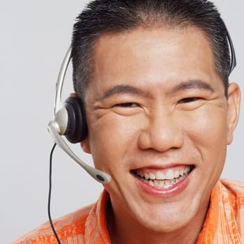 Portrait of a mid adult man wearing a headset and smiling