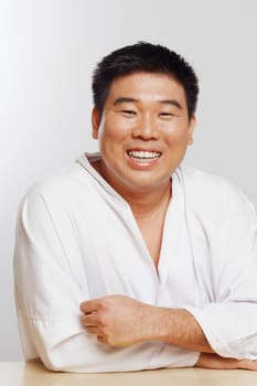 Portrait of a mid adult man wearing a karate uniform and smiling