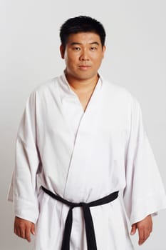 Portrait of a mid adult man wearing a karate uniform