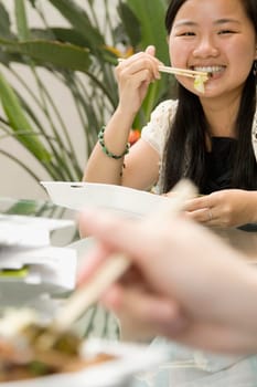 Portrait of a female office worker having lunch and smiling