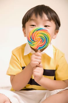 Close-up of a boy holding a candy
