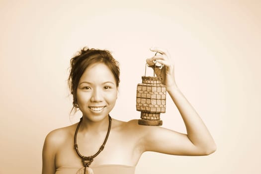 Portrait of a young woman holding a lantern and smiling