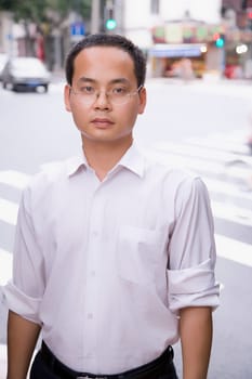 Portrait of a young man standing on a road
