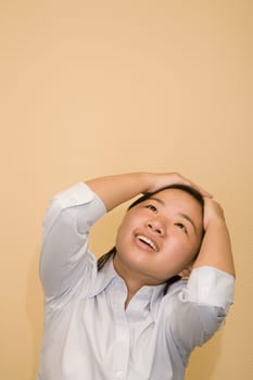 Close-up of a young woman with her head in her hands