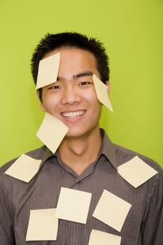 Portrait of a male office worker covered with adhesive notes