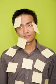 Close-up of a male office worker covered with adhesive notes