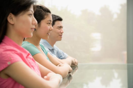 Three office workers sitting in a conference room