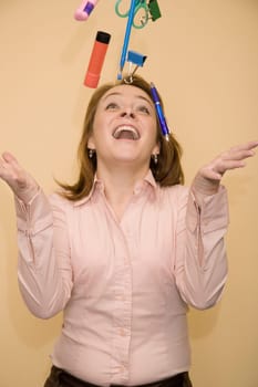 Close-up of a mid adult woman tossing stationery objects