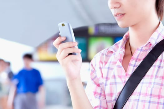 Close-up of a young man text messaging on a mobile phone